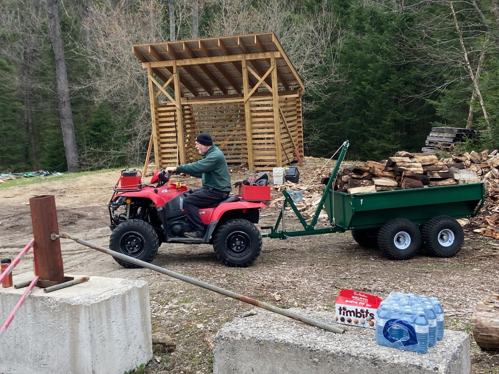 Woodshare volunteer helps gather and stack firewood to be delivered to those who need it.